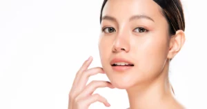 Woman with glowing skin touching her face after skin resurfacing in MONROE, GA
