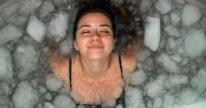 A person experiencing cold plunge therapy in Watkinsville, GA, an ice bath for recovery